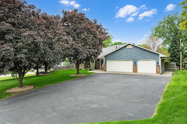 843 Northdale Blvd NW, Coon Rapids, MN 55448 - view of front of home with asphalt driveway, a front yard, a garage, and brick siding