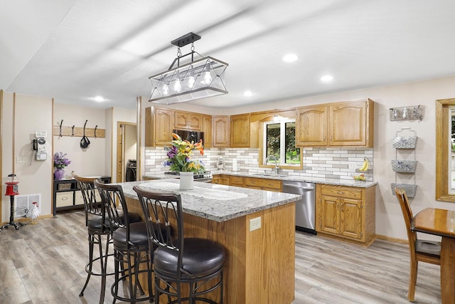 843 Northdale Blvd NW, Coon Rapids, MN 55448 - kitchen featuring stainless steel appliances, a sink, light stone counters, a breakfast bar area, and light wood-style floors