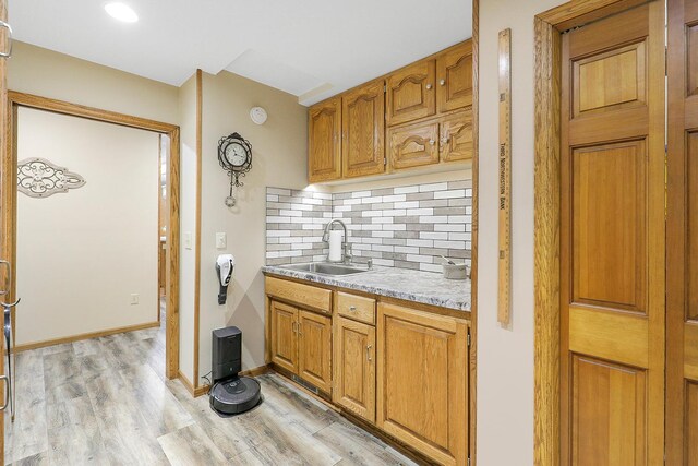 843 Northdale Blvd NW, Coon Rapids, MN 55448 - kitchen with a sink, light countertops, decorative backsplash, light wood-type flooring, and brown cabinetry