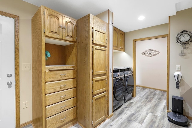 843 Northdale Blvd NW, Coon Rapids, MN 55448 - kitchen with washing machine and dryer, light wood-style flooring, baseboards, and brown cabinetry