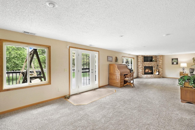 843 Northdale Blvd NW, Coon Rapids, MN 55448 - living room featuring a textured ceiling, carpet floors, a fireplace, and baseboards