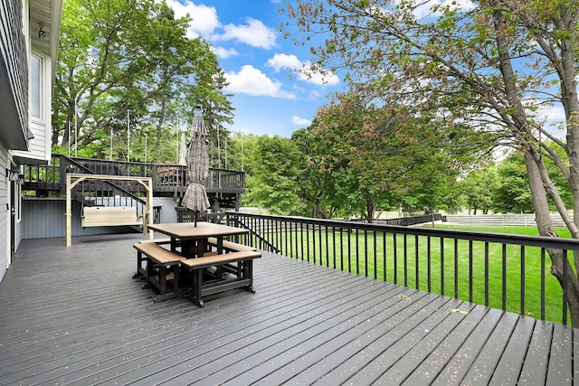 843 Northdale Blvd NW, Coon Rapids, MN 55448 - wooden deck with outdoor dining area, view of wooded area, and stairs