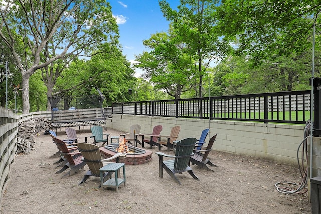 843 Northdale Blvd NW, Coon Rapids, MN 55448 - fenced backyard with a fire pit and view of wooded area