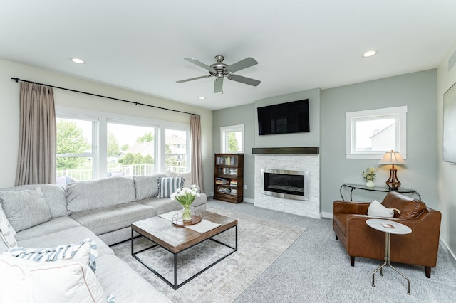 927 Southwell Enclave NE, Byron, MN 55920 - living room with carpet floors, a stone fireplace, ceiling fan, baseboards, and recessed lighting