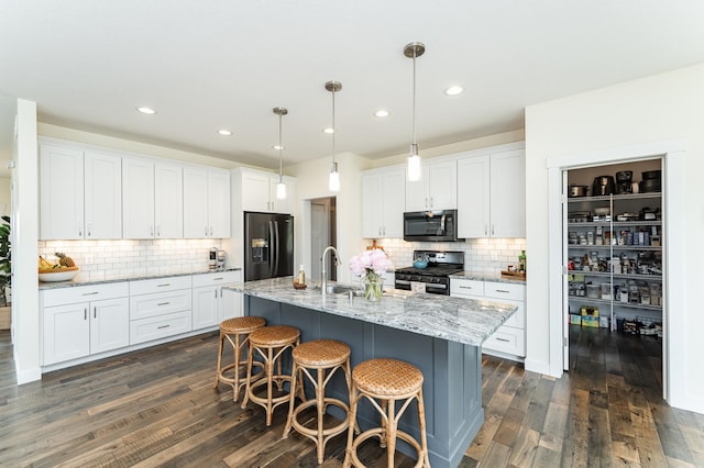 927 Southwell Enclave NE, Byron, MN 55920 - kitchen with stainless steel range oven, refrigerator with ice dispenser, backsplash, white cabinets, and recessed lighting