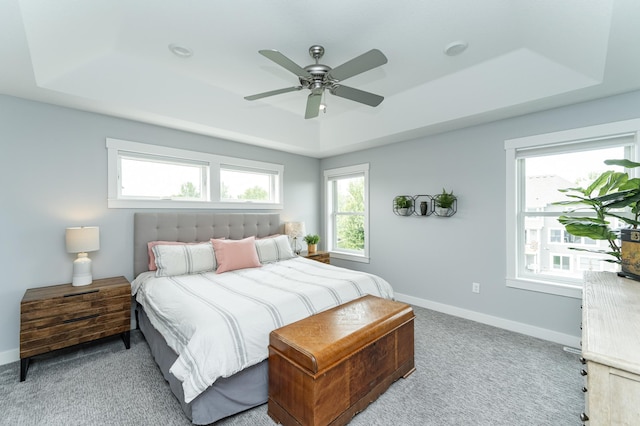 927 Southwell Enclave NE, Byron, MN 55920 - bedroom with a tray ceiling, baseboards, carpet floors, and a ceiling fan