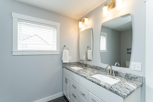 927 Southwell Enclave NE, Byron, MN 55920 - full bathroom with double vanity, baseboards, tile patterned floors, and toilet