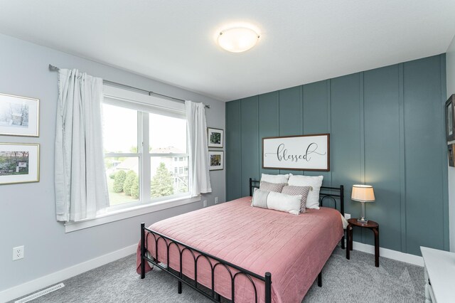 927 Southwell Enclave NE, Byron, MN 55920 - bedroom with light colored carpet, baseboards, and a decorative wall