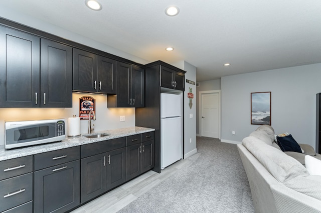 927 Southwell Enclave NE, Byron, MN 55920 - kitchen with stainless steel microwave, a sink, freestanding refrigerator, open floor plan, and recessed lighting