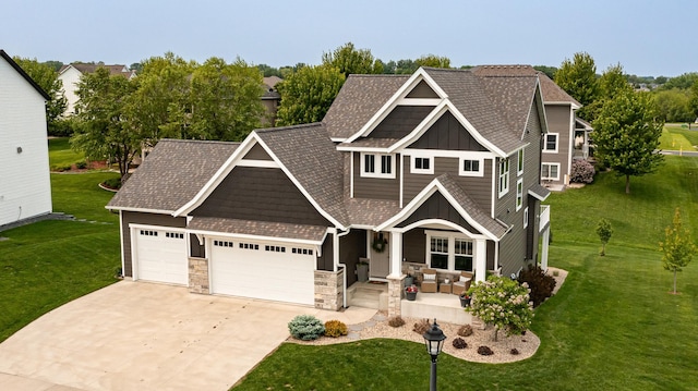 927 Southwell Enclave NE, Byron, MN 55920 - craftsman-style home with board and batten siding, a garage, stone siding, driveway, and a porch