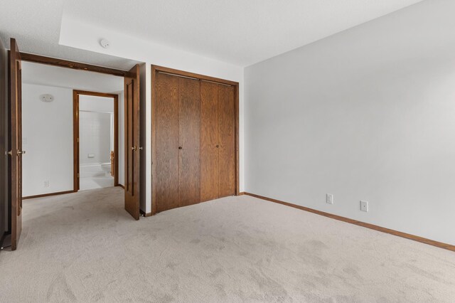 9700 Portland Ave S Unit 237, Bloomington, MN 55420 - unfurnished bedroom with carpet floors, a closet, and baseboards