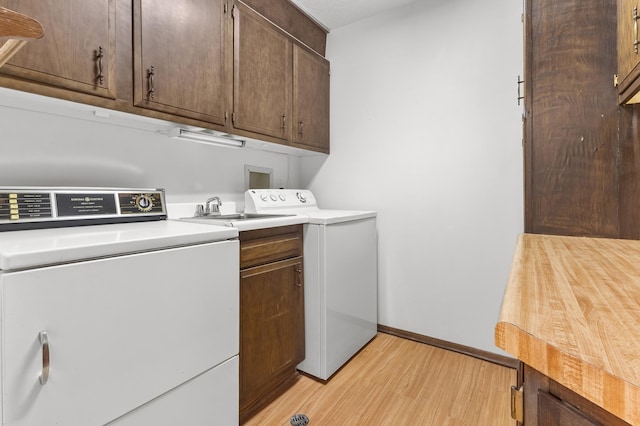 9700 Portland Ave S Unit 237, Bloomington, MN 55420 - washroom featuring washer / clothes dryer, cabinet space, light wood finished floors, and baseboards