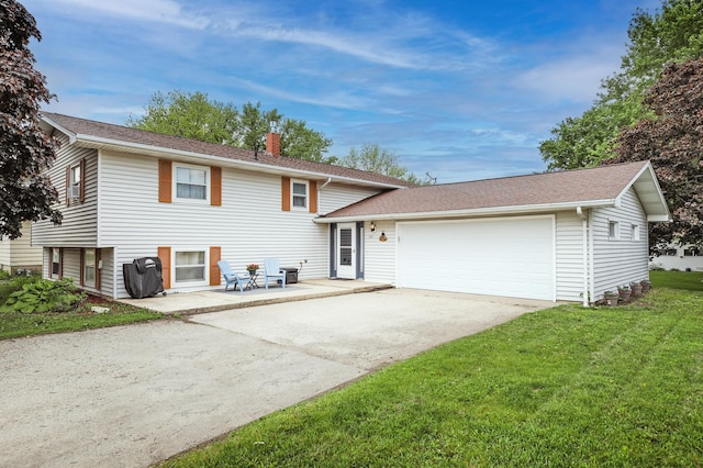 208 Concord St, West Concord, MN 55985 - split level home featuring a chimney, a front lawn, a garage, driveway, and roof with shingles