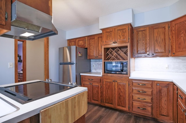 208 Concord St, West Concord, MN 55985 - kitchen with black microwave, freestanding refrigerator, wall chimney range hood, light countertops, and electric cooktop