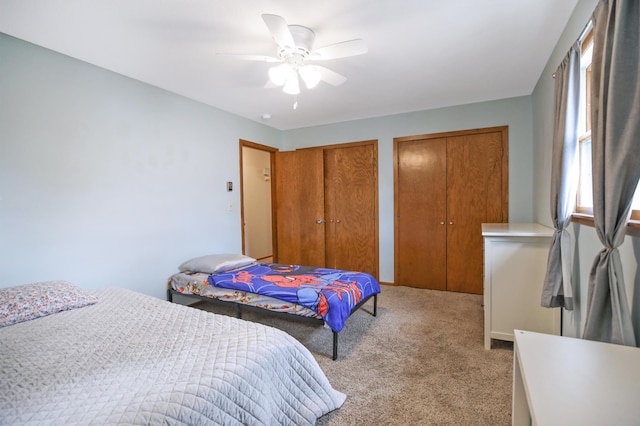 208 Concord St, West Concord, MN 55985 - bedroom with multiple closets, light colored carpet, and a ceiling fan