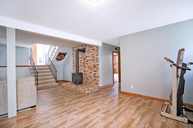 208 Concord St, West Concord, MN 55985 - exercise area with wood finished floors, a wood stove, and baseboards