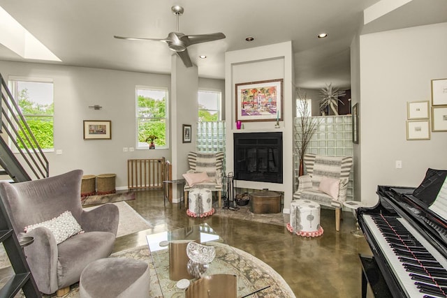 512 Laurel Ave Unit 1, Saint Paul, MN 55102 - living area featuring radiator heating unit, a glass covered fireplace, ceiling fan, and recessed lighting
