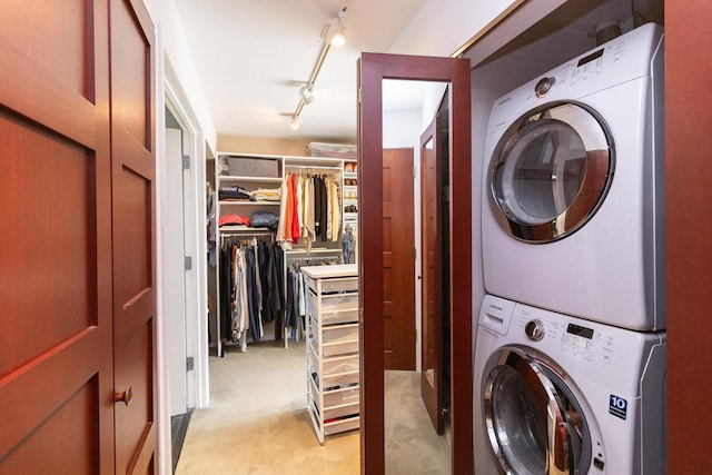 512 Laurel Ave Unit 1, Saint Paul, MN 55102 - laundry room with estacked washer and dryer and light carpet