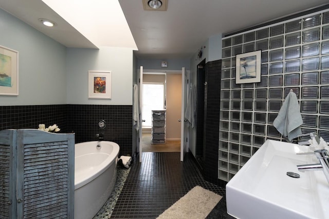 512 Laurel Ave Unit 1, Saint Paul, MN 55102 - bathroom with tile walls, a freestanding tub, tile patterned flooring, and wainscoting