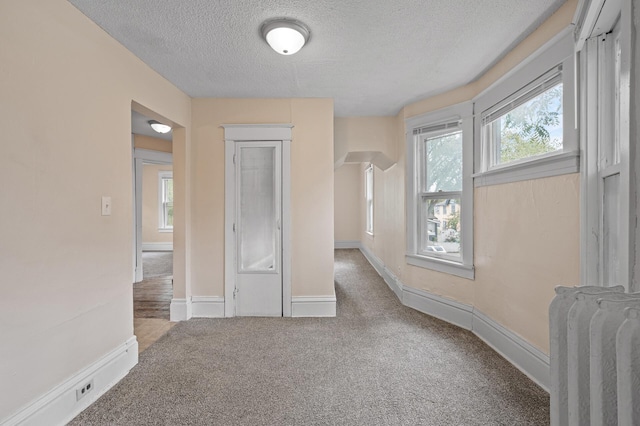 3328 5th Ave S, Minneapolis, MN 55408 - unfurnished bedroom with a textured ceiling, carpet flooring, and baseboards