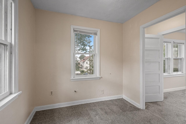 3328 5th Ave S, Minneapolis, MN 55408 - spare room featuring carpet floors, baseboards, and a textured ceiling