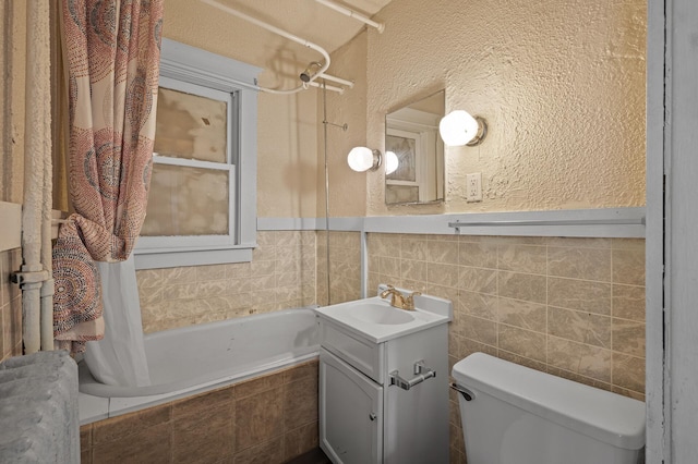 3328 5th Ave S, Minneapolis, MN 55408 - bathroom with tiled shower / bath, vanity, toilet, a textured wall, and tile walls