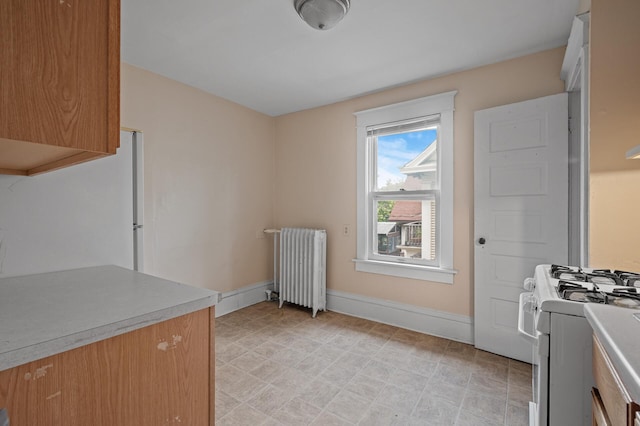 3328 5th Ave S, Minneapolis, MN 55408 - laundry area featuring radiator heating unit and baseboards