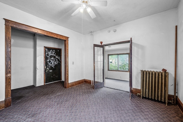 3328 5th Ave S, Minneapolis, MN 55408 - spare room featuring radiator heating unit, carpet floors, ceiling fan, a textured ceiling, and baseboards