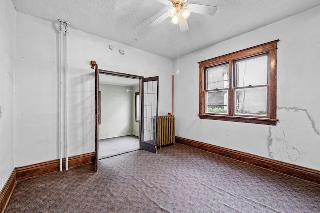 3328 5th Ave S, Minneapolis, MN 55408 - carpeted empty room with radiator, a textured ceiling, baseboards, and ceiling fan