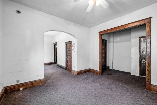 3328 5th Ave S, Minneapolis, MN 55408 - carpeted empty room featuring arched walkways, a ceiling fan, baseboards, and a textured ceiling