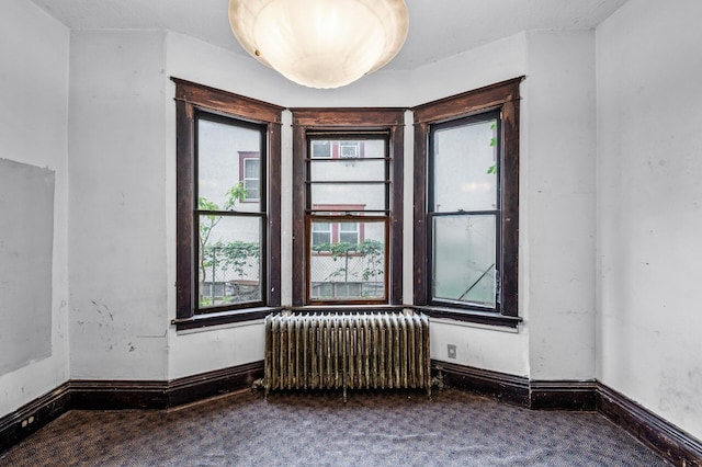 3328 5th Ave S, Minneapolis, MN 55408 - unfurnished room featuring radiator heating unit, carpet floors, and baseboards