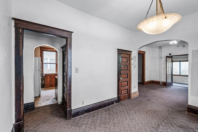 3328 5th Ave S, Minneapolis, MN 55408 - spare room featuring carpet floors, arched walkways, and healthy amount of natural light