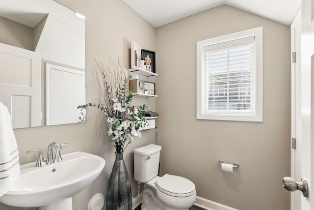 1141 Middlefield Rd, Medina, MN 55340 - half bathroom with a sink, toilet, vaulted ceiling, and baseboards