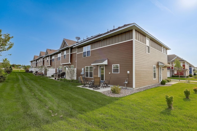 1141 Middlefield Rd, Medina, MN 55340 - rear view of house featuring a patio, a lawn, board and batten siding, and a residential view