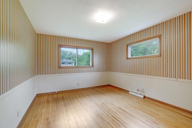 11418 Friar Ln, Minnetonka, MN 55305 - spare room with wood-type flooring, a baseboard radiator, and baseboards