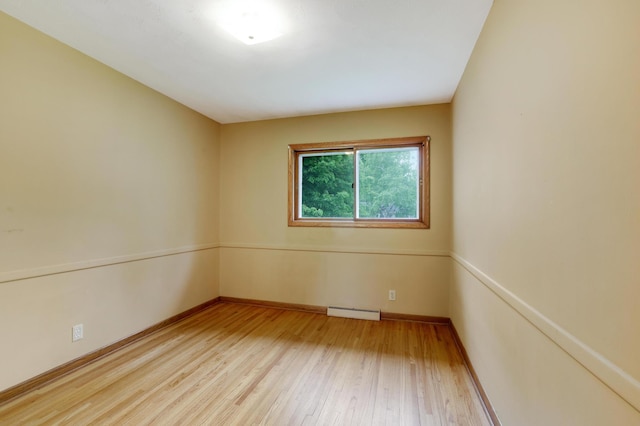 11418 Friar Ln, Minnetonka, MN 55305 - spare room with wood finished floors, baseboards, and a baseboard heating unit