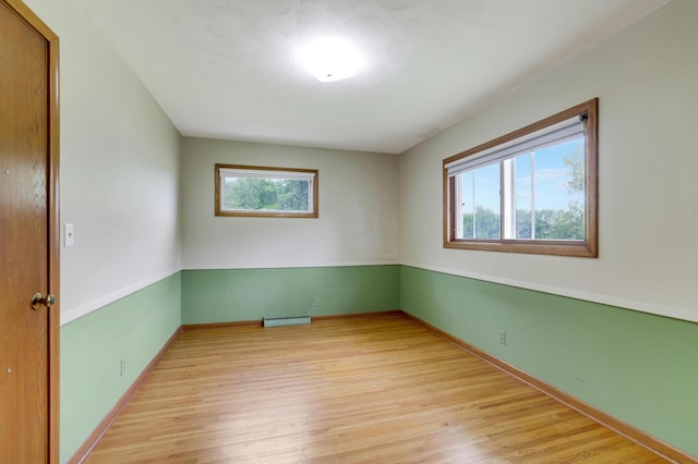 11418 Friar Ln, Minnetonka, MN 55305 - empty room featuring light wood finished floors, baseboards, and a baseboard radiator