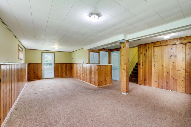 11418 Friar Ln, Minnetonka, MN 55305 - basement with wood walls, stairs, carpet floors, and wainscoting