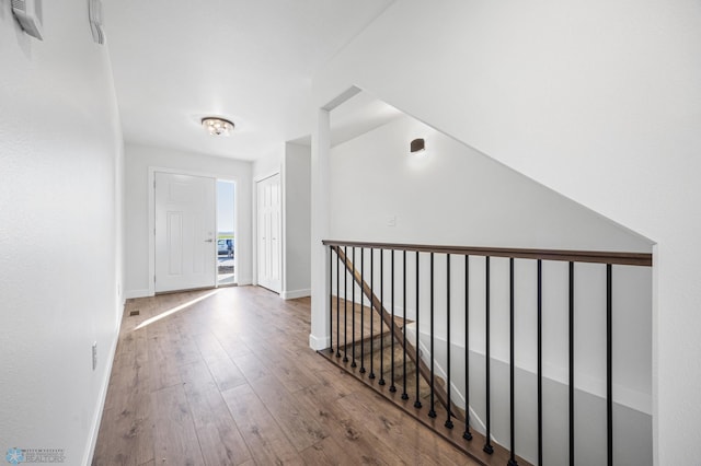 8378 62nd St S, Horace, ND 58047 - hallway with wood-type flooring, an upstairs landing, and baseboards