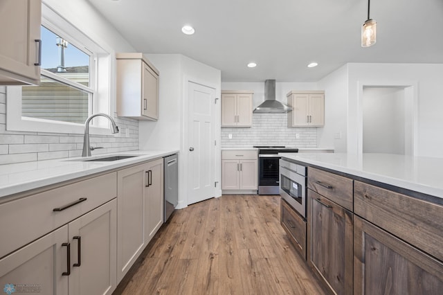 8378 62nd St S, Horace, ND 58047 - kitchen featuring wall chimney range hood, appliances with stainless steel finishes, a sink, backsplash, and light wood-type flooring