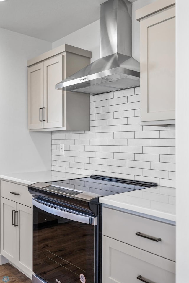 8378 62nd St S, Horace, ND 58047 - kitchen featuring stainless steel range with electric stovetop, wall chimney exhaust hood, decorative backsplash, and dark wood-style flooring