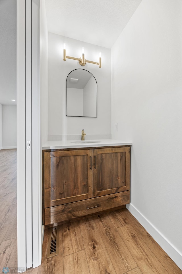 8378 62nd St S, Horace, ND 58047 - bathroom with hardwood / wood-style flooring, vanity, and baseboards