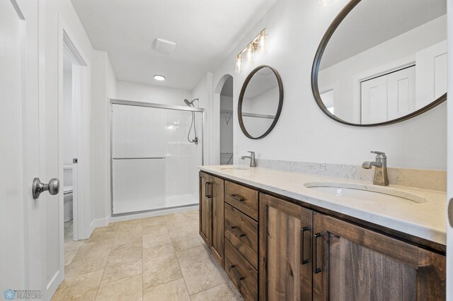 8378 62nd St S, Horace, ND 58047 - full bath with double vanity, a stall shower, toilet, and tile patterned flooring