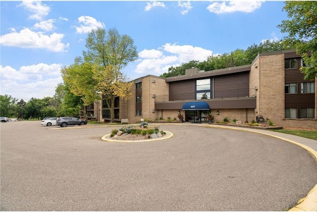 5697 Green Circle Dr Unit 304, Minnetonka, MN 55343 - view of building exterior with uncovered parking