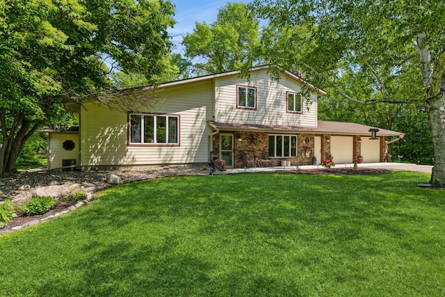 8935 180th St W, Faribault, MN 55021 - view of front of home with a garage, a front yard, and concrete driveway