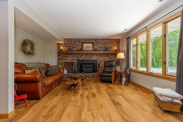8935 180th St W, Faribault, MN 55021 - living area with wood finished floors, baseboards, and a brick fireplace