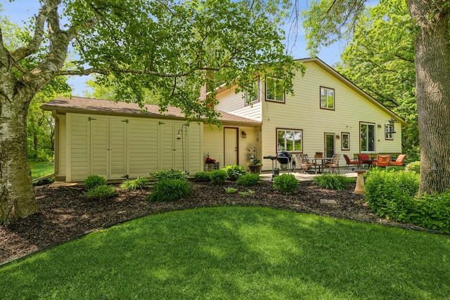 8935 180th St W, Faribault, MN 55021 - rear view of house featuring a patio, a lawn, and outdoor lounge area