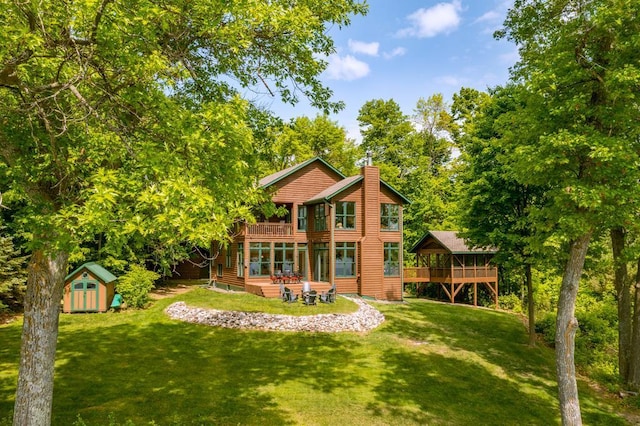 19260 Lakewood Dr, Deerwood Twp, MN 56444 - rear view of house with a wooden deck, a lawn, and a chimney