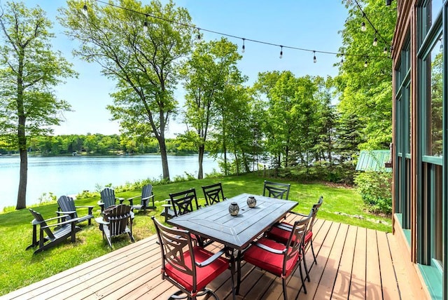 19260 Lakewood Dr, Deerwood Twp, MN 56444 - wooden deck featuring a water view, outdoor dining area, and a lawn