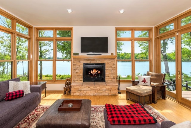 19260 Lakewood Dr, Deerwood Twp, MN 56444 - living room with healthy amount of natural light, wood finished floors, and a fireplace